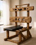 Wooden pillory bench in burnt wood finish with black padded supports