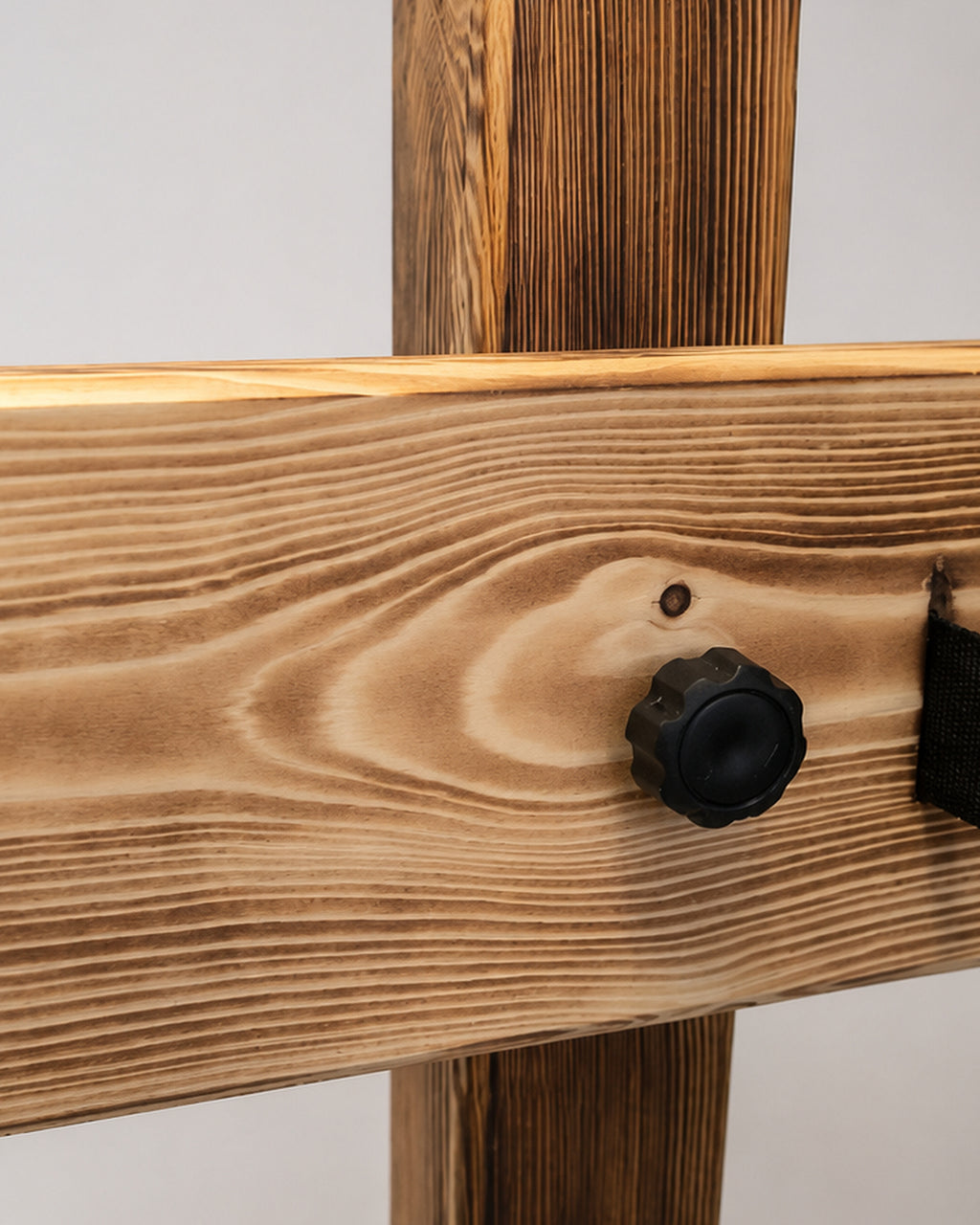 Close-up of wooden adjustment knob and burnt wood grain