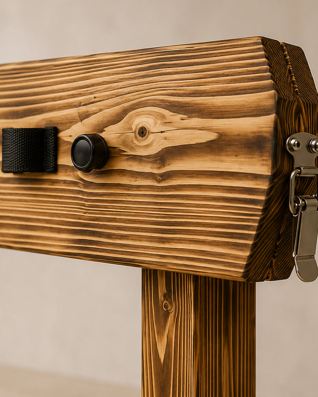 Upper wooden pillory frame with black straps and metal hardware