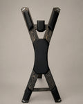 Front view of a freestanding St. Andrew’s Cross in dark-finished spruce with black padded supports