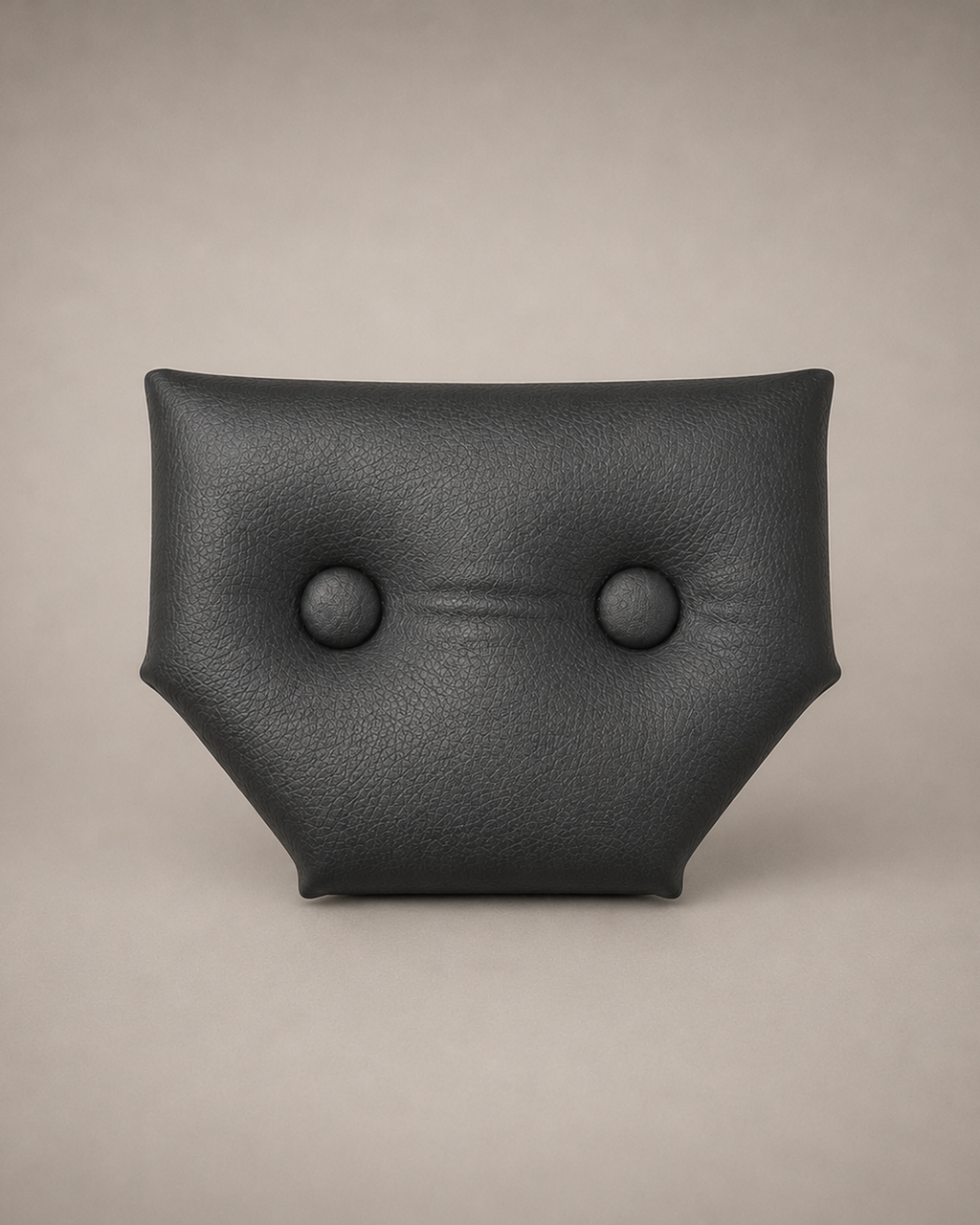 Close-up of the small black eco-leather headrest with two upholstered buttons for a modular wall-mounted St. Andrew’s Cross